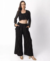 Женский черно-золотой брючный костюм палаццо с укороченным топом с длинными рукавами от RAAS