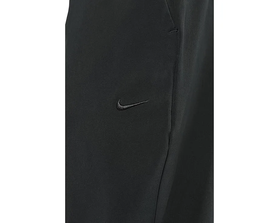 Брюки Nike Unlimited Dri FIT с зауженным кроем и карманами на молнии