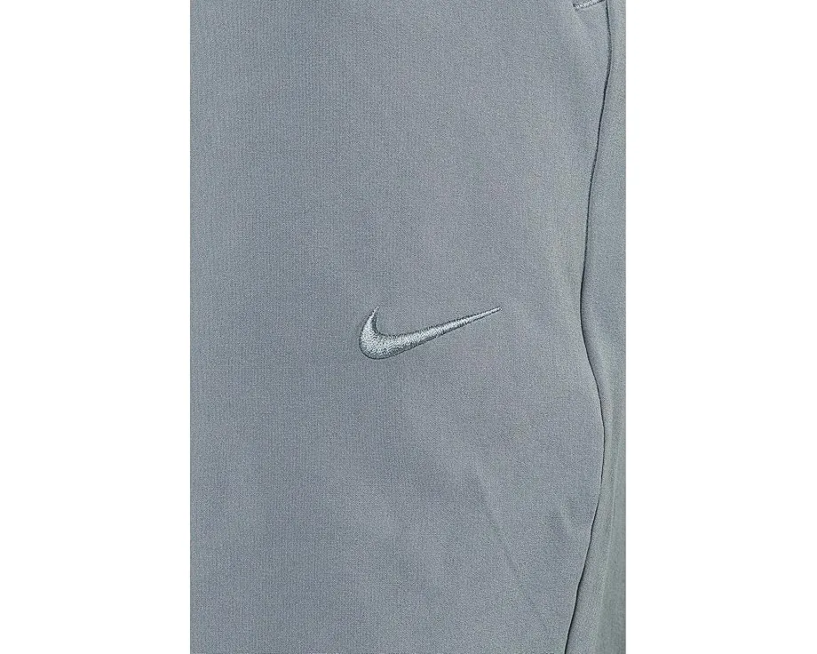 Брюки Nike Unlimited Dri FIT с зауженным кроем и карманами на молнии