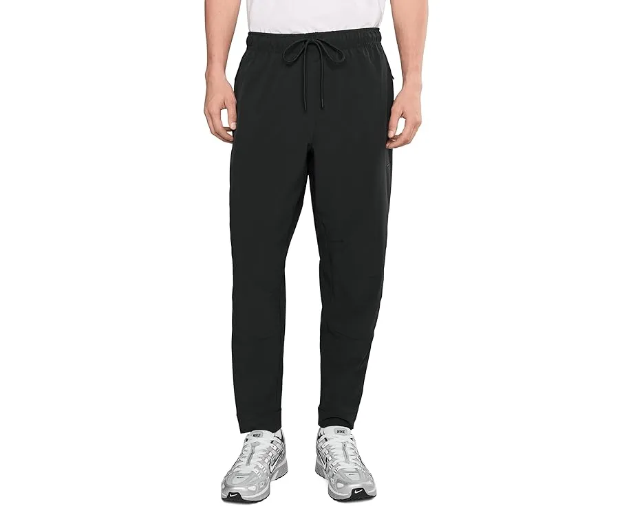 Брюки Nike Unlimited Dri FIT с зауженным кроем и карманами на молнии