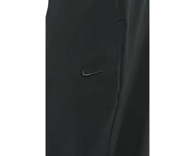 Брюки Nike Unlimited Dri FIT с зауженным кроем и карманами на молнии